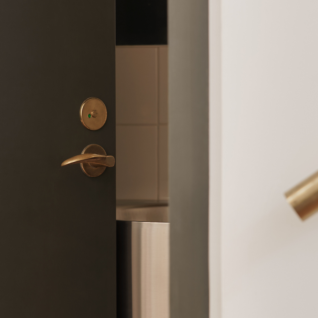PVD satin brass d line Arne Jacobsen lever on a door.