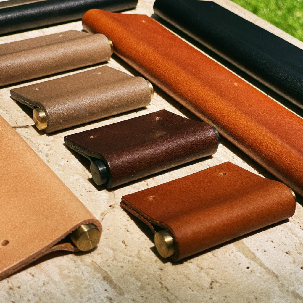 Chapman & Bose EP01 leather edge pulls on wood in mixed colours.