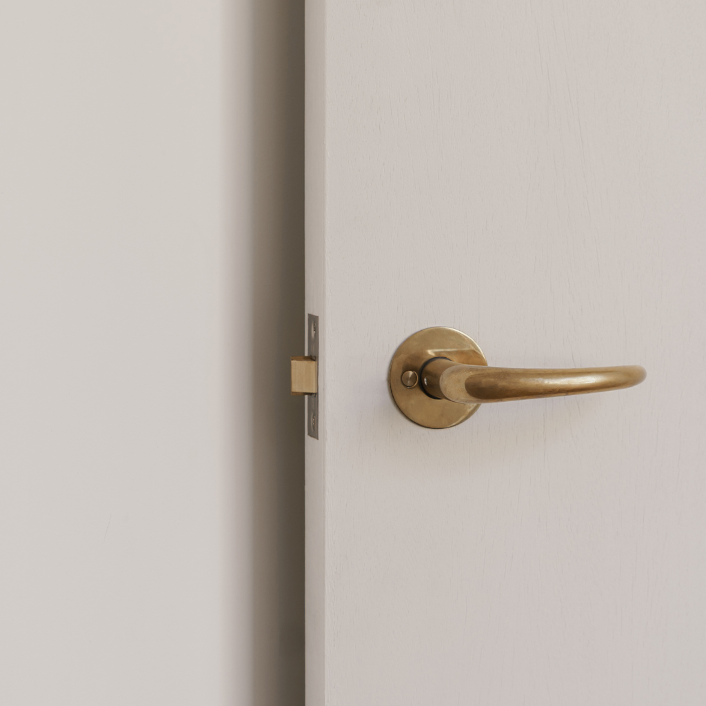 PVD satin brass d line Kay Otto Fisker door lever on a door.